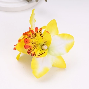 Detailed close-up of a realistic yellow and white silk orchid flower hair clip