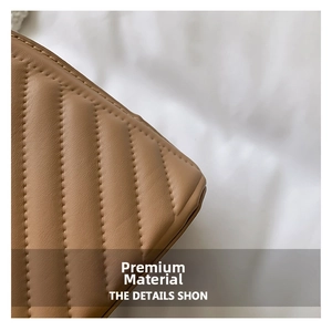 Detailed close-up of brown quilted faux leather texture with elegant V-stitch pattern