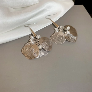 Detail of silver layered petal earrings with pearls and silk ribbon texture