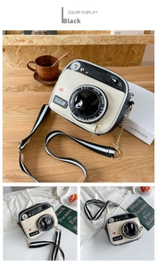 Detailed view of a creative camera-shaped crossbody bag with black and white color blocking
