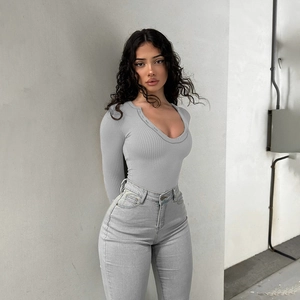 Detailed texture of grey ribbed knit long sleeve bodysuit with buttoned neckline