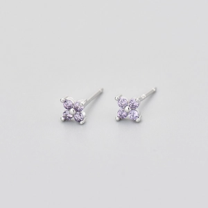 Macro shot of S925 silver four-petal flower earrings with purple zircons