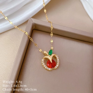 Detailed view of apple pendant with red stone, dimensions 1.6x1.8cm on a 40cm chain