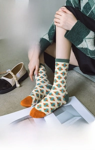 Detailed view of argyle patterned cotton crew socks with vibrant vintage color blocking