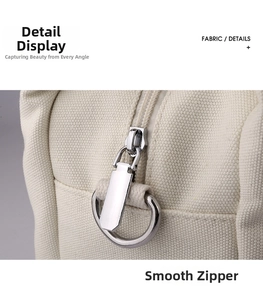 Close-up of canvas bag silver zipper with large metal ring pull and fine stitching