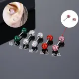 Detail of colorful crystal paved ball earrings showing various colors and wear effect
