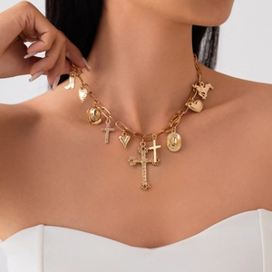 Golden Western necklace with cross, cowboy hat, boots, and heart pendants on a model