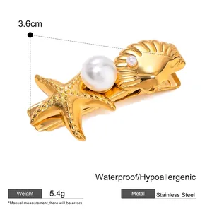 Detail of stainless steel hair clip with golden starfish, shell and pearl decor