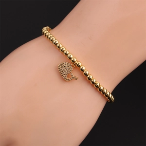 Gold elastic pearl bead bracelet for women featuring a sparkling dolphin zircon charm