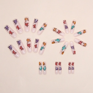 Summer glitter press-on nails with colorful graffiti art and vibrant splatter patterns