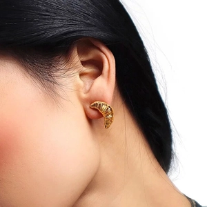 Classic 18K gold plated croissant dome stud earrings worn by a model in a close-up view