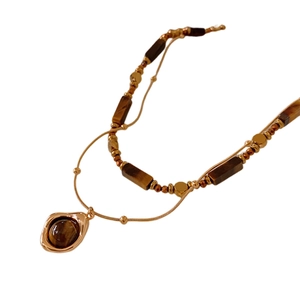 Gold plated tiger eye stone layered necklace with irregular lava pendant design