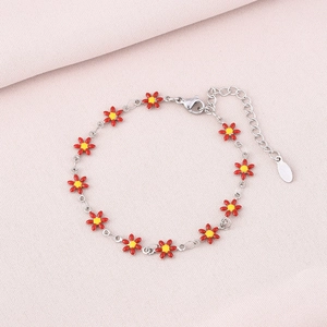 Detail showing red daisy flower petal charms on a silver stainless steel bracelet
