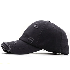 Detailed side view of distressed cotton baseball cap with vintage frayed hole textures