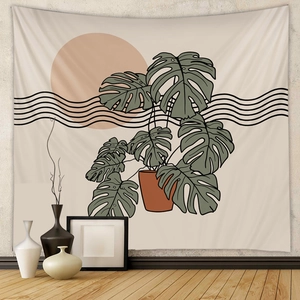 Bohemian tapestry featuring a monstera plant art and sunset waves on a neutral wall