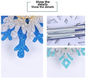 Detail view of the sparkly blue and silver snowflake hair clip with metal duckbill clip