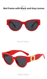 Detail of red cat eye sunglasses featuring gold-tone temple accents and dark grey lenses