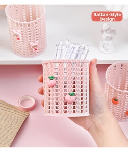 Detail of pink faux-rattan desk organizer with a 3D peach charm and woven texture