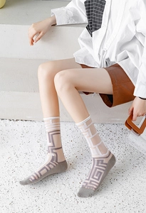 Detail view of Japanese style sheer crew socks with grey geometric patterns on mesh fabric
