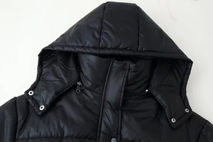 Close-up of hooded puffer jacket neck details with glossy fabric and metal hardware