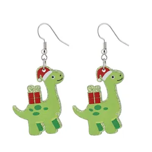 Macro view of green acrylic dinosaur earrings with glitter and festive Christmas hats