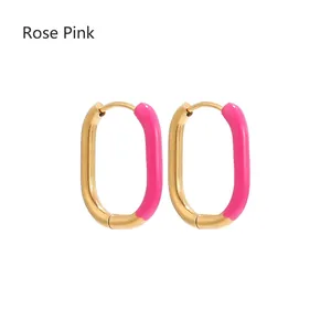 Detail view of U-shaped rose red enamel earrings with polished gold-plated finish