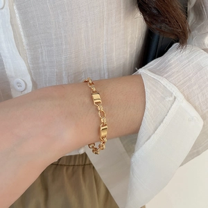 Detailed view of 18k gold plated chain bracelet with rectangular and twisted round links