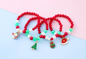 Detail of four colorful beaded Christmas bracelets with snowman and tree charms