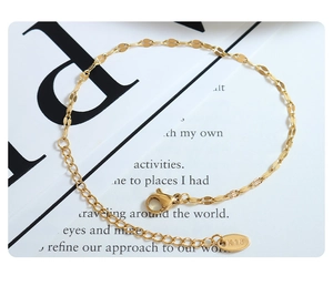 Detailed macro view of 18K gold plated lip chain with adjustable extension and lobster clasp