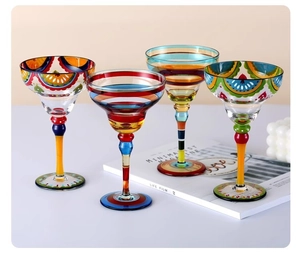 Detailed view of hand-painted crystal cocktail glasses with colorful geometric patterns