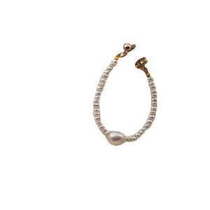 Elegant freshwater pearl smile necklace with gold clasp on minimalist white background