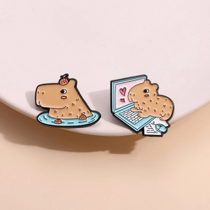 Cute capybara enamel pin set featuring capybara with orange and working at computer