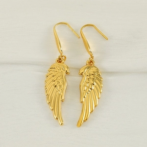 Minimalist golden feather wing dangle earrings made of stainless steel on white fabric
