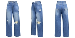Detail van de distressed kniegaten en gewassen denimtextuur op high-waist jeans met wijde pijp