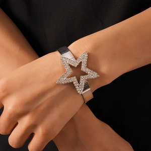 Detail view of silver star cuff bracelet with sparkling rhinestones on a model's wrist