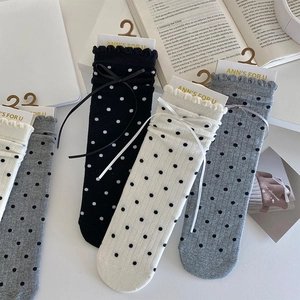 Detailed set of ruffled socks with polka dots and bow tie accents in classic colors