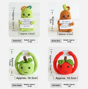 Detail showing four styles of hand-knitted fruit dolls with inspirational cards on soft base