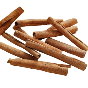 Natural dried cinnamon sticks stacked on a white background for Christmas decor
