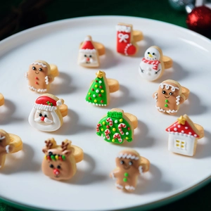 12-piece set of festive Christmas ring cookies with colorful icing on white ceramic plate