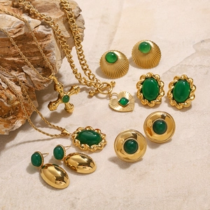 Golden stainless steel jewelry set with emerald green stones and heart pendant necklace