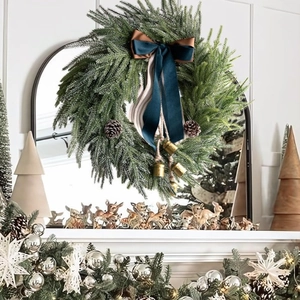 Artificial Christmas wreath with pine cones, golden bells and dark blue velvet bow