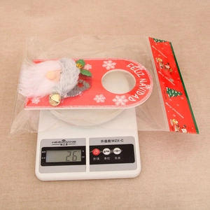 Detail view of Santa Claus wine bottle hanger on weight scale for Christmas decoration