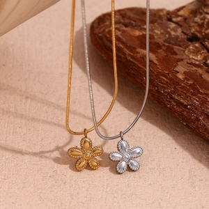 Detailed view of flower pendant necklaces in gold and silver finish with sleek snake chains