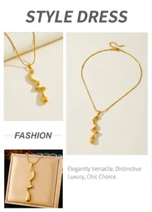 Detail of gold-plated wavy fluid pendant necklace with snake chain and lobster clasp