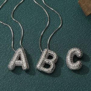 Silver iced out bubble letter pendant with sparkling CZ stones on box chain