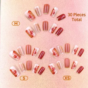 Cat eye red floral press-on nails set with gold edges and glitter details, 30 pieces