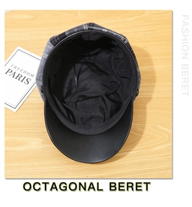 Detail view of plaid wool beret showing black leather brim and adjustable inner lining