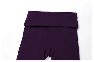 Detail of high-waist foldover yoga leggings in deep purple with reinforced stitching