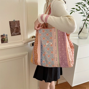 Close-up of vintage floral canvas tote bag with Sozakka label in a lifestyle setting