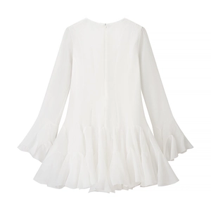 Flat lay of white long sleeve dress with layered ruffle hem and back zipper detail